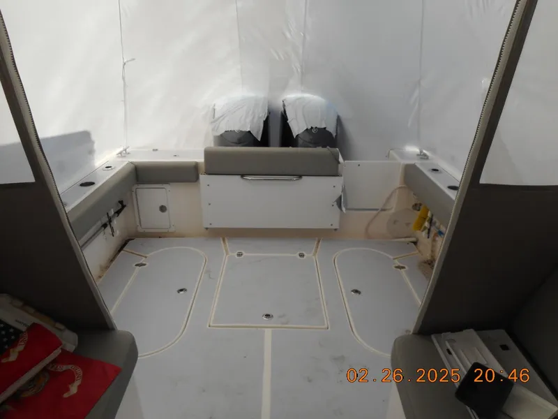 Slide: The Image of 2024 NorthCoast 255HT boat interior with dual engines, spacious seating, and storage compartments. - 30