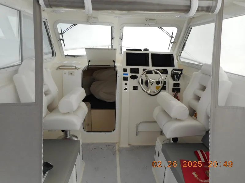 Slide: The Image of 2024 NorthCoast 255HT boat interior with helm, seating, and navigation equipment. - 31