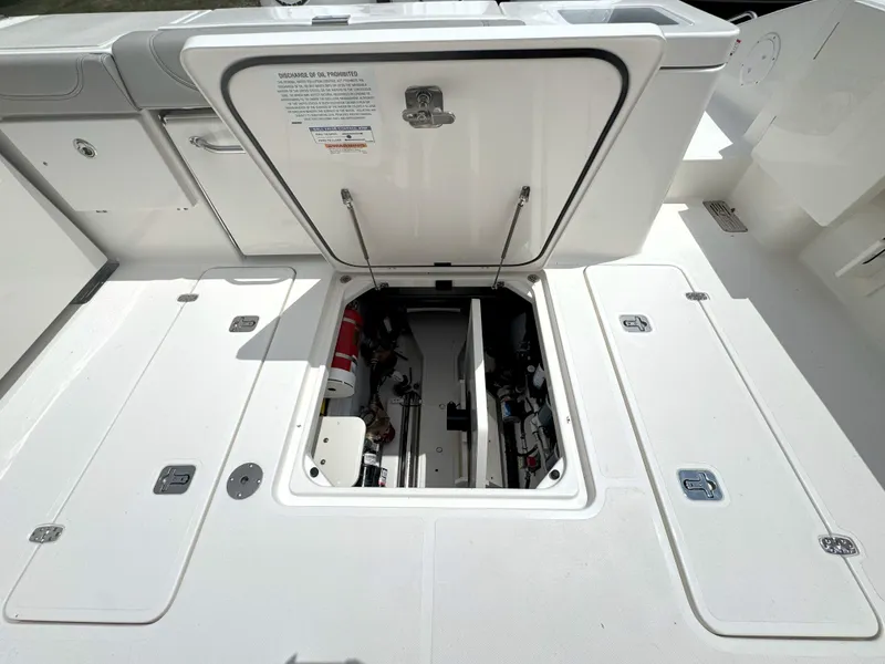 Slide: The Image of 2025 Pursuit OS 355 Offshore boat deck with open storage compartment. - 10