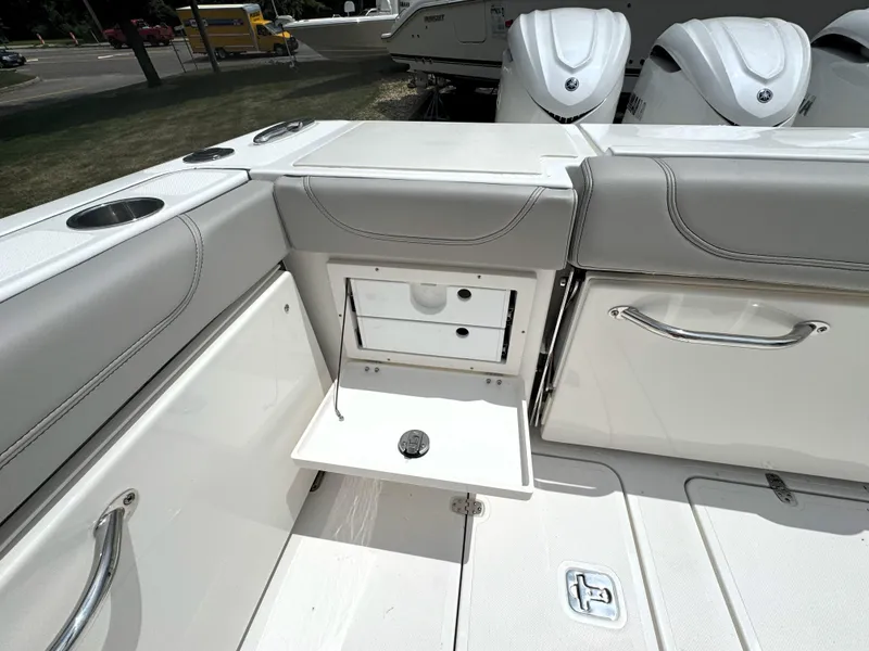 Slide: The Image of 2025 Pursuit OS 355 Offshore boat interior with storage compartment and seating. - 11