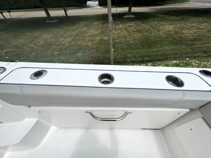 Slide: The Image of 2025 Pursuit OS 355 Offshore boat interior with cup holders and sleek design. - 12