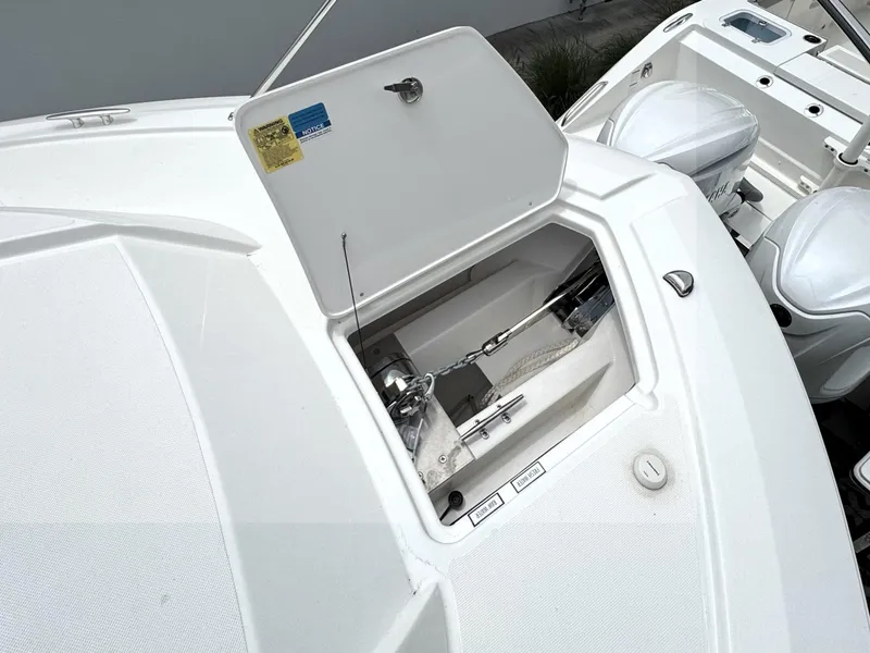 Slide: The Image of 2025 Pursuit OS 355 Offshore boat anchor compartment with open hatch. - 14