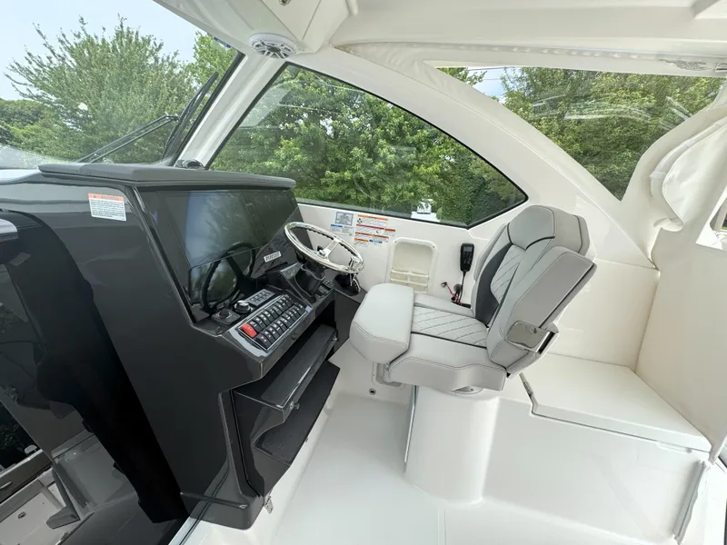 Slide: The Image of 2025 Pursuit OS 355 Offshore helm with modern controls and comfortable seating. - 18