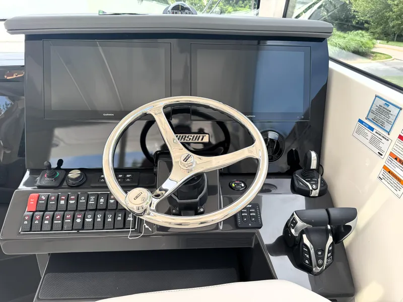 Slide: The Image of 2025 Pursuit OS 355 Offshore helm with dual screens and advanced controls. - 19