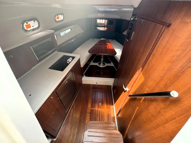 Slide: The Image of Luxurious interior of 2025 Pursuit OS 355 Offshore boat with modern kitchen and seating area. - 24