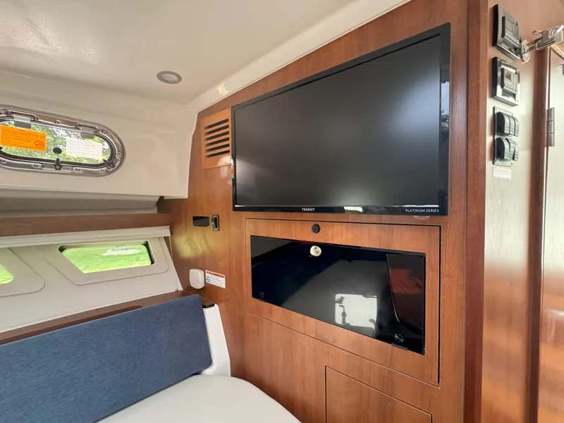 Slide: The Image of Interior of 2025 Pursuit OS 355 Offshore with TV and wooden paneling. - 25