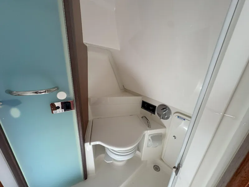 Slide: The Image of 2025 Pursuit OS 355 Offshore boat bathroom with modern fixtures and compact design. - 29