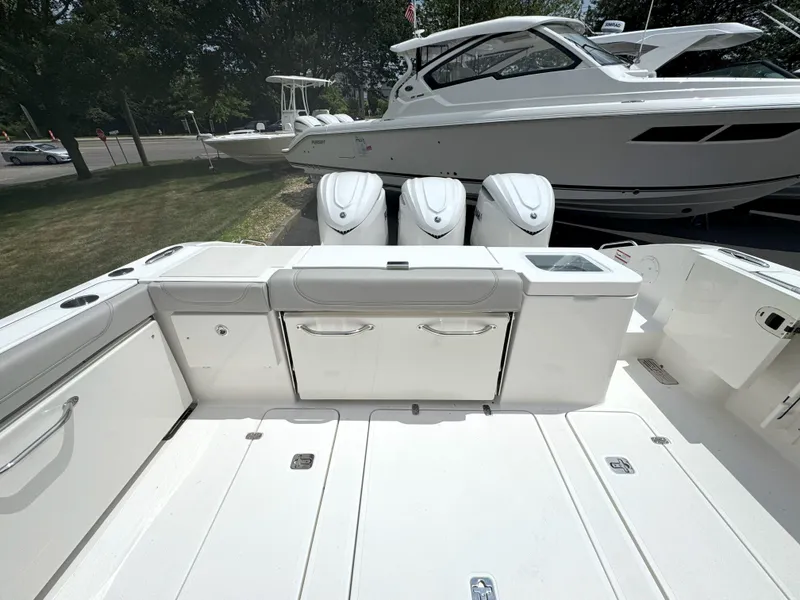 Slide: The Image of 2025 Pursuit OS 355 Offshore boat with triple outboard engines, spacious deck, and sleek design. - 7