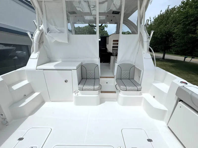Slide: The Image of 2025 Pursuit OS 355 Offshore boat interior with seating and storage compartments. - 9