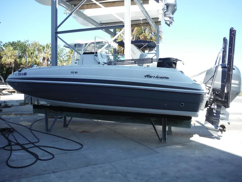 Slide: The Image of 2019 Hurricane Center Console 21 OB boat on a lift, side view. - 0