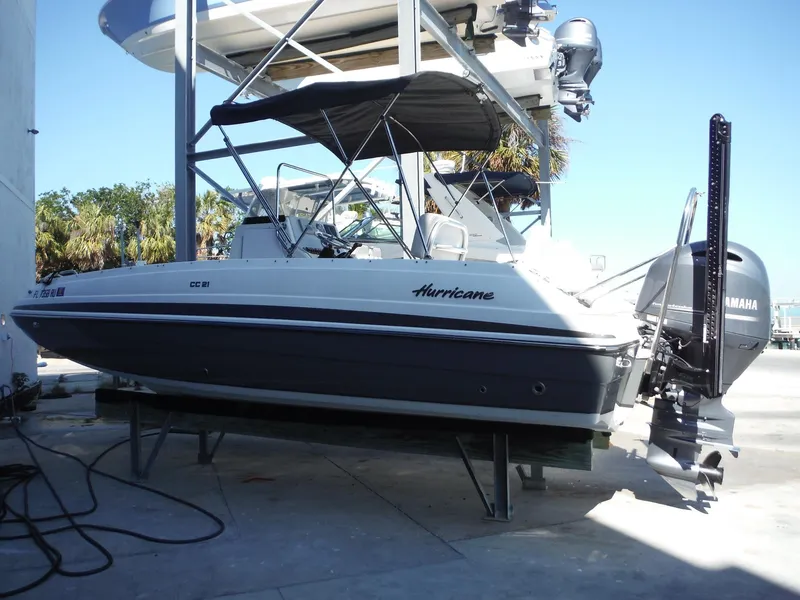 Slide: The Image of 2019 Hurricane Center Console 21 OB boat with Yamaha outboard motor, docked outdoors. - 1
