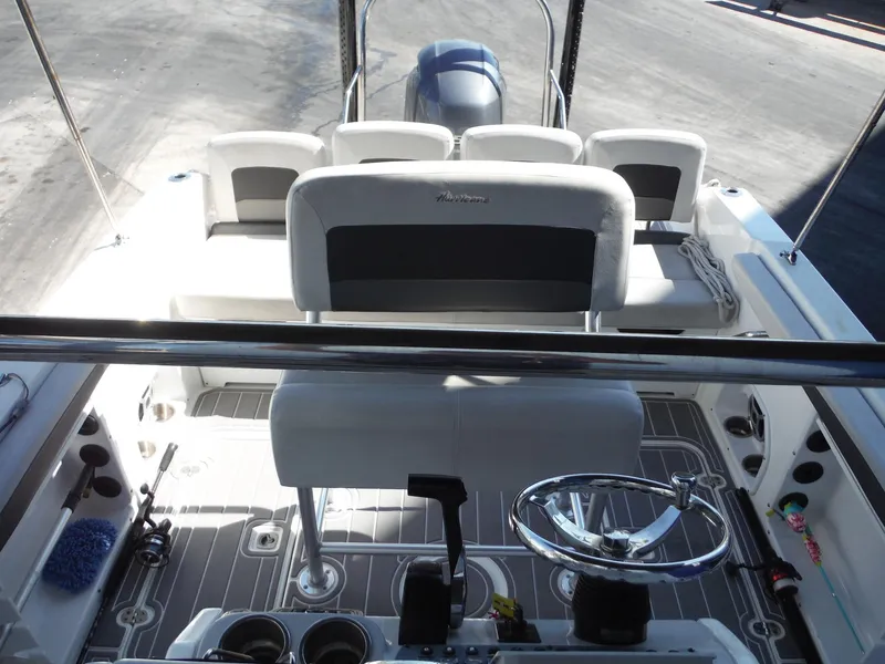 Slide: The Image of 2019 Hurricane Center Console 21 OB boat interior with seating and steering wheel. - 11