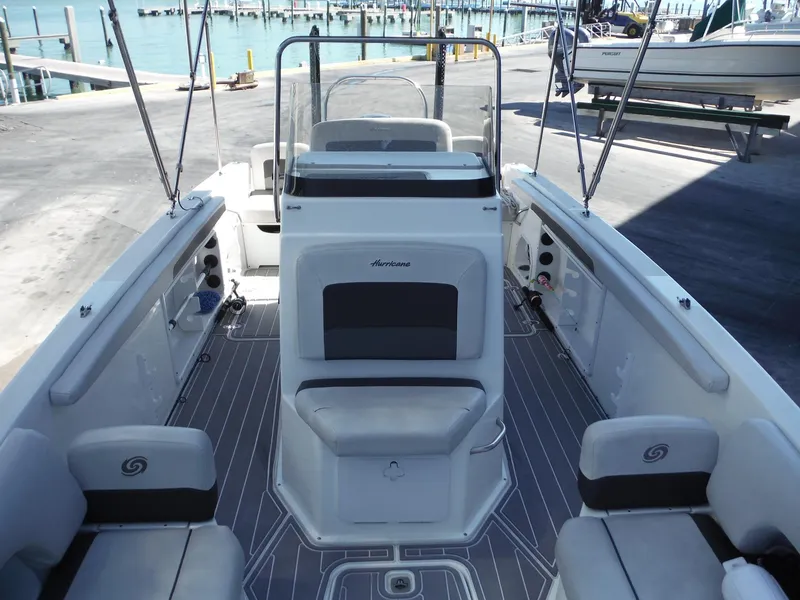 Slide: The Image of 2019 Hurricane Center Console 21 OB boat interior with seating and console, dockside view. - 13
