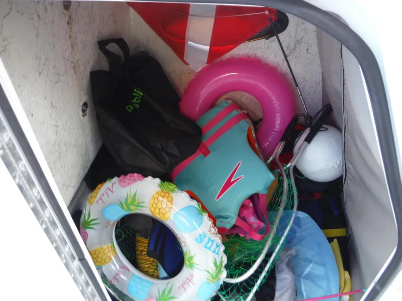 Slide: The Image of Storage compartment of 2019 Hurricane Center Console 21 OB with life vests and inflatables. - 16
