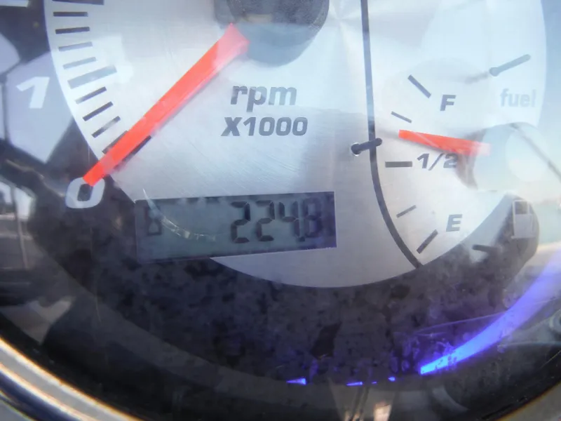 Slide: The Image of Close-up of a 2019 Hurricane Center Console 21 OB tachometer and fuel gauge. - 17