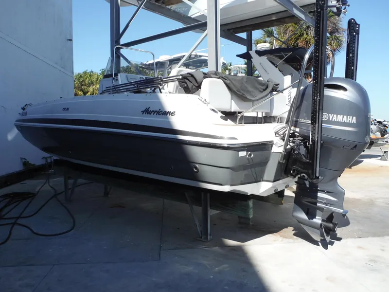 Slide: The Image of 2019 Hurricane Center Console 21 OB boat with Yamaha outboard motor on a lift. - 2