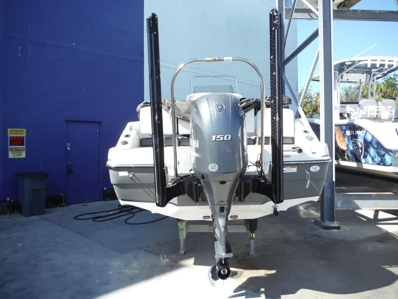 Slide: The Image of 2019 Hurricane Center Console 21 OB boat with Yamaha 150 outboard motor in a marina. - 3