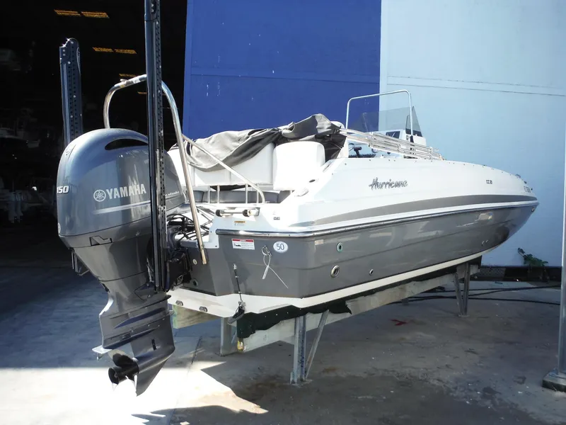 Slide: The Image of 2019 Hurricane Center Console 21 OB boat with Yamaha outboard motor in storage. - 4