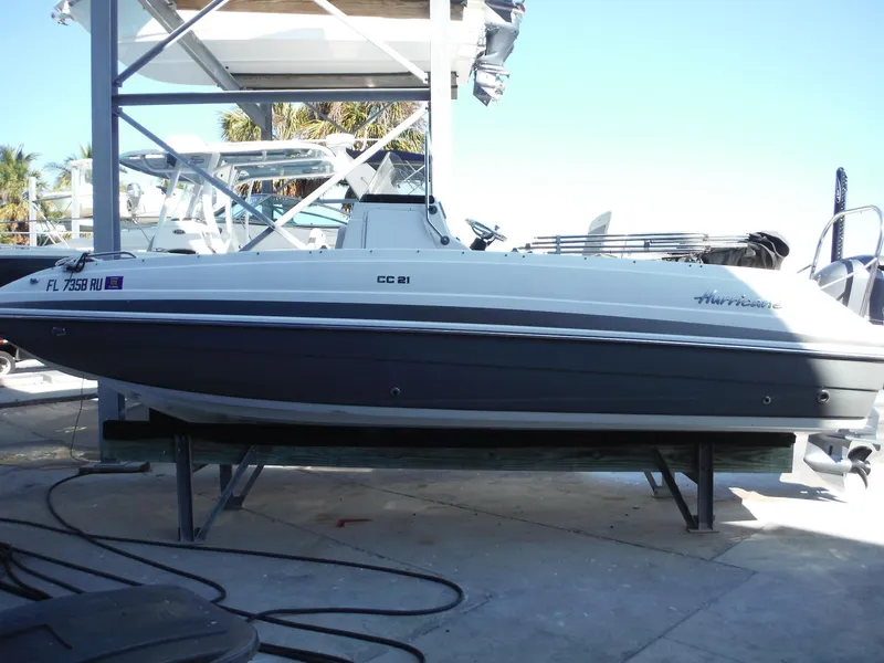Slide: The Image of 2019 Hurricane Center Console 21 OB boat on a lift, side view. - 6
