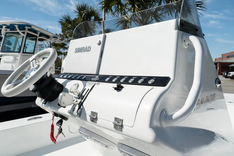 Slide: The Image of 2025 Turner Boatworks 24 SAVAGE console with steering wheel and controls. - 10