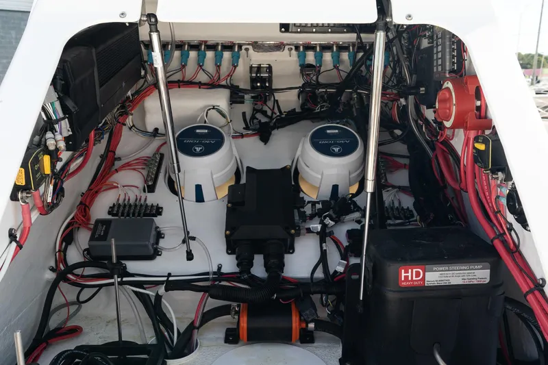Slide: The Image of Engine compartment of 2025 Turner Boatworks 24 SAVAGE, showcasing wiring and components. - 19