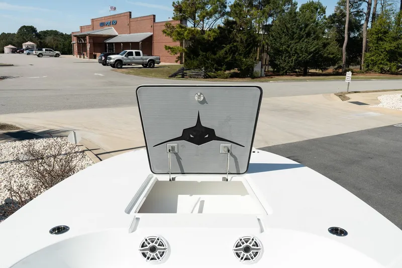 Slide: The Image of 2025 Turner Boatworks 24 SAVAGE with open hatch, parked near a building. - 20