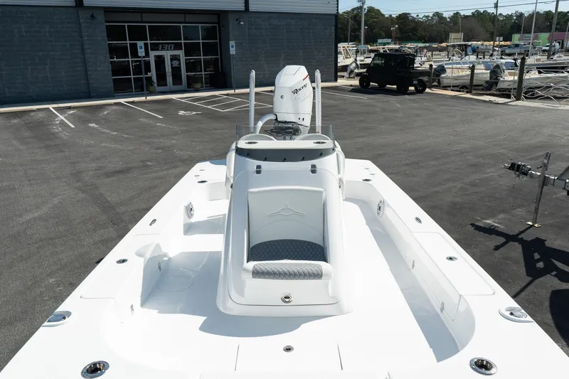 Slide: The Image of 2025 Turner Boatworks 24 SAVAGE, sleek white deck, parked outdoors. - 21