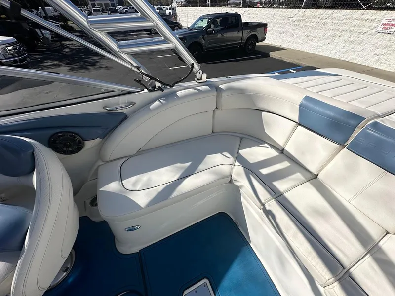 Slide: The Image of 2012 Bayliner 235 Bowrider interior with white and blue seating. - 14