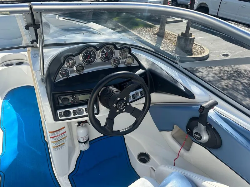 Slide: The Image of Interior view of 2012 Bayliner 235 Bowrider boat dashboard and steering wheel. - 21