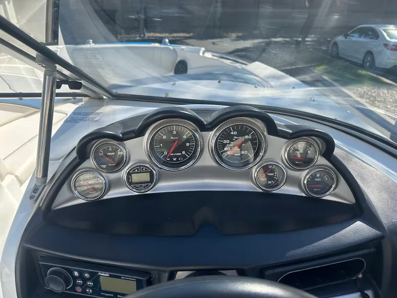 Slide: The Image of Dashboard of a 2012 Bayliner 235 Bowrider boat with gauges and controls. - 22
