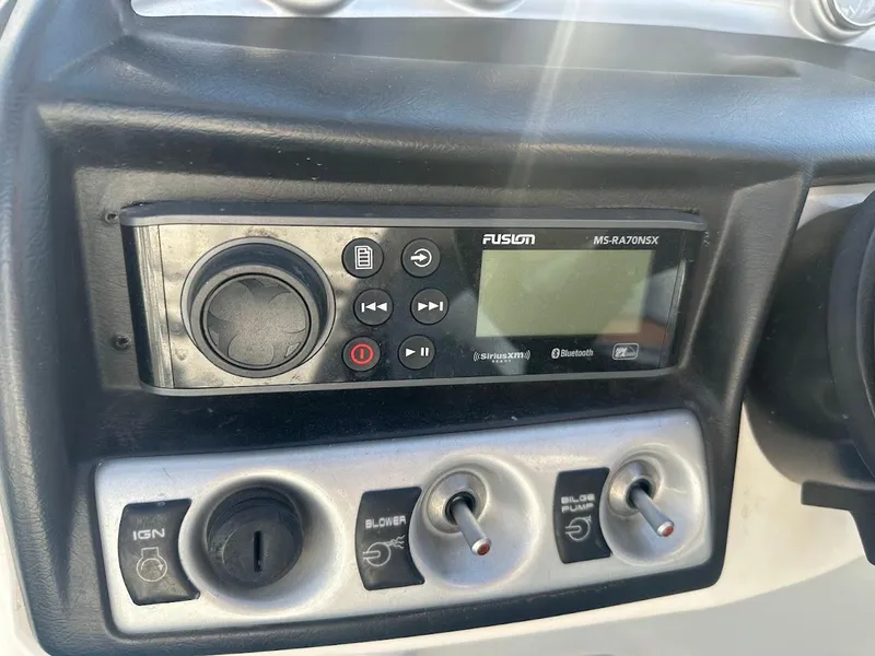 Slide: The Image of 2012 Bayliner 235 Bowrider dashboard with Fusion MS-RA70NSX stereo and control switches. - 23