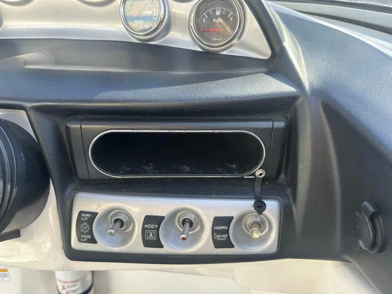 Slide: The Image of Dashboard controls of a 2012 Bayliner 235 Bowrider boat. - 24