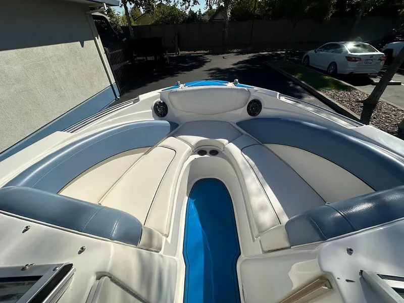 Slide: The Image of 2012 Bayliner 235 Bowrider boat interior with blue and white seating. - 26