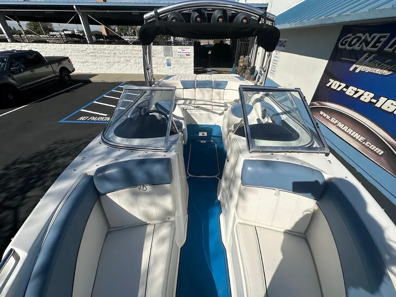 Slide: The Image of 2012 Bayliner 235 Bowrider with white and blue interior, parked outdoors. - 28