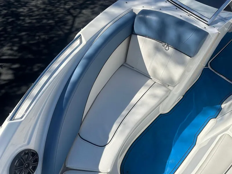 Slide: The Image of 2012 Bayliner 235 Bowrider boat interior with blue and white seating. - 29