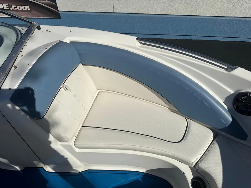 Slide: The Image of 2012 Bayliner 235 Bowrider boat interior with white seating and blue accents. - 30