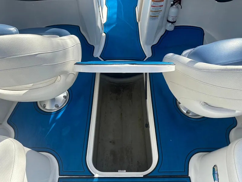 Slide: The Image of 2012 Bayliner 235 Bowrider interior with blue flooring and white seating. - 37