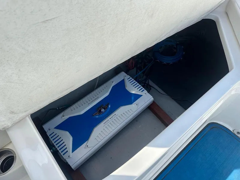 Slide: The Image of Storage compartment in 2012 Bayliner 235 Bowrider boat with blue and white equipment. - 40
