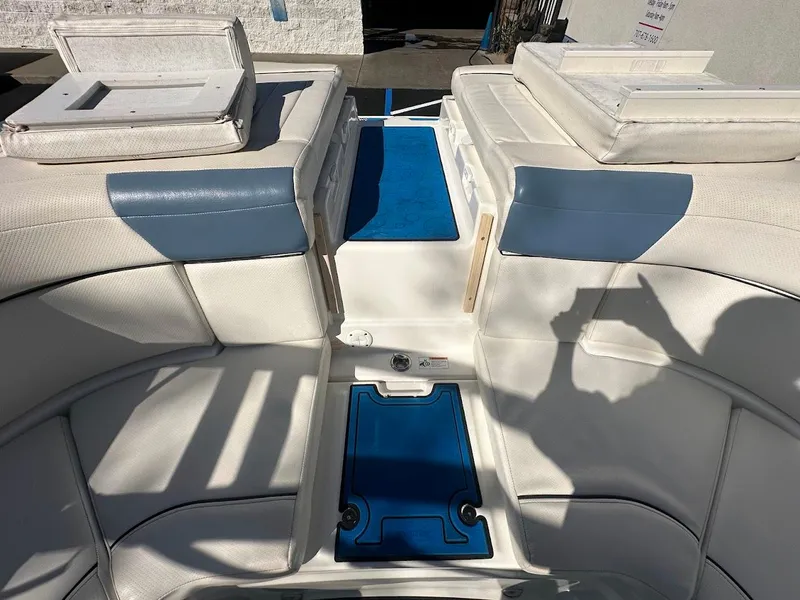 Slide: The Image of 2012 Bayliner 235 Bowrider interior with white and blue seating and deck. - 44