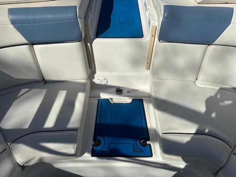 Slide: The Image of 2012 Bayliner 235 Bowrider interior with white and blue seating and flooring. - 45