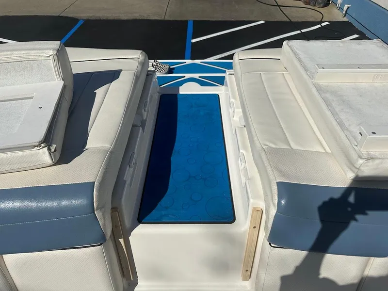 Slide: The Image of 2012 Bayliner 235 Bowrider interior with white and blue seating. - 46