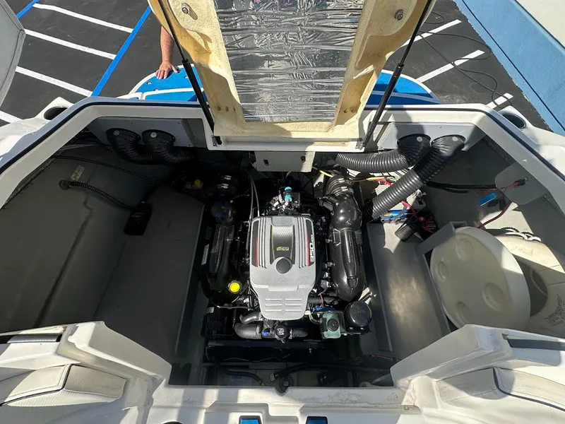 Slide: The Image of 2012 Bayliner 235 Bowrider engine compartment with open hatch, showcasing the engine. - 47