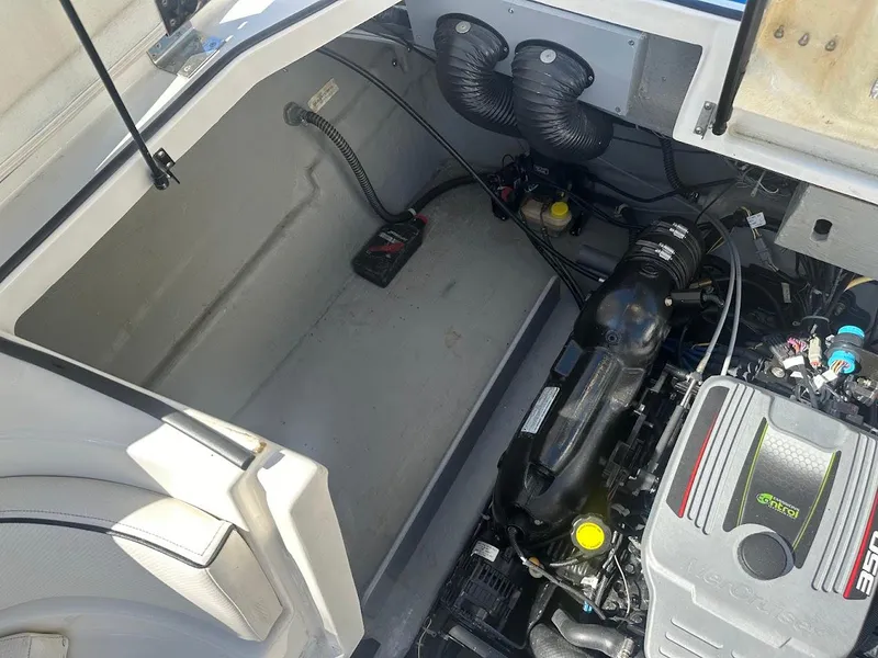 Slide: The Image of Engine compartment of 2012 Bayliner 235 Bowrider boat, showcasing mechanical components. - 48