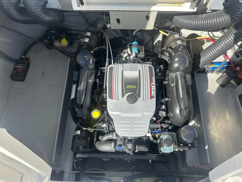 Slide: The Image of Engine compartment of 2012 Bayliner 235 Bowrider, showcasing a powerful inboard motor. - 49