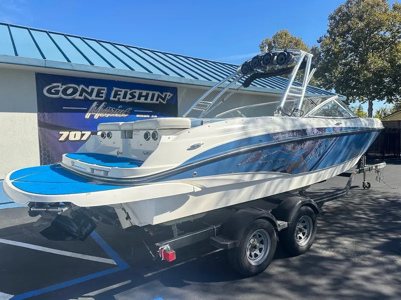 Slide: The Image of 2012 Bayliner 235 Bowrider boat on trailer, parked outside Gone Fishin' store. - 6