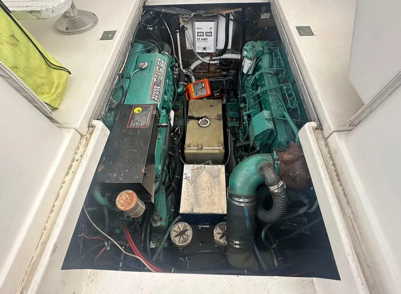 Slide: The Image of Engine compartment of a 1998 Phoenix 32 Tournament boat, showcasing dual engines and components. - 17