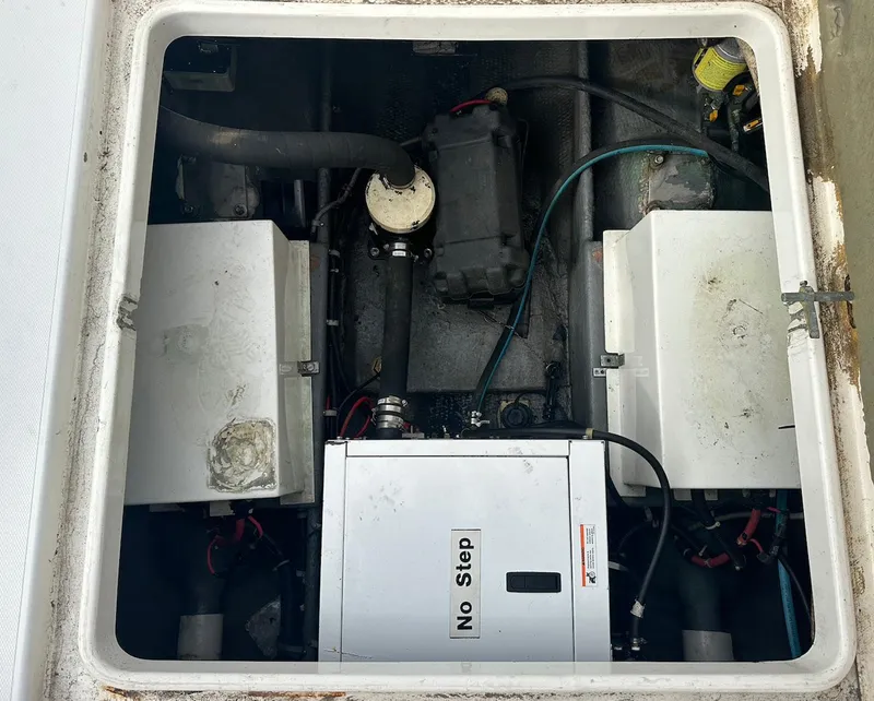 Slide: The Image of Engine compartment of a 1998 Phoenix 32 Tournament boat, showing mechanical components. - 21