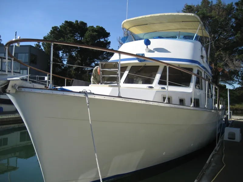 The Image of 1976 Tollycraft 48 Cockpit Motor Yacht docked in a marina, side view. - 0