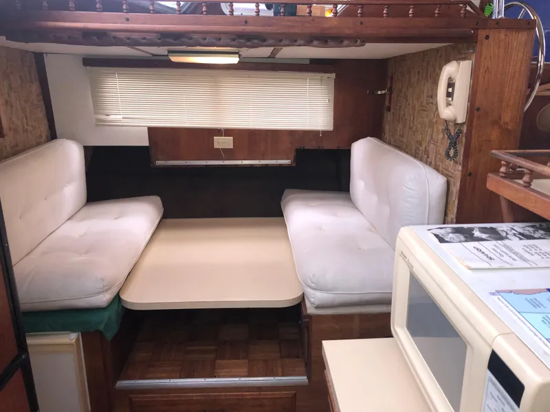 Slide: The Image of 1976 Tollycraft 48 Cockpit Motor Yacht interior with cozy seating and table. - 15