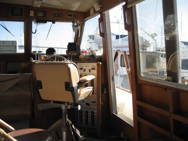 Slide: The Image of Interior of 1976 Tollycraft 48 Cockpit Motor Yacht with helm and control panel. - 16